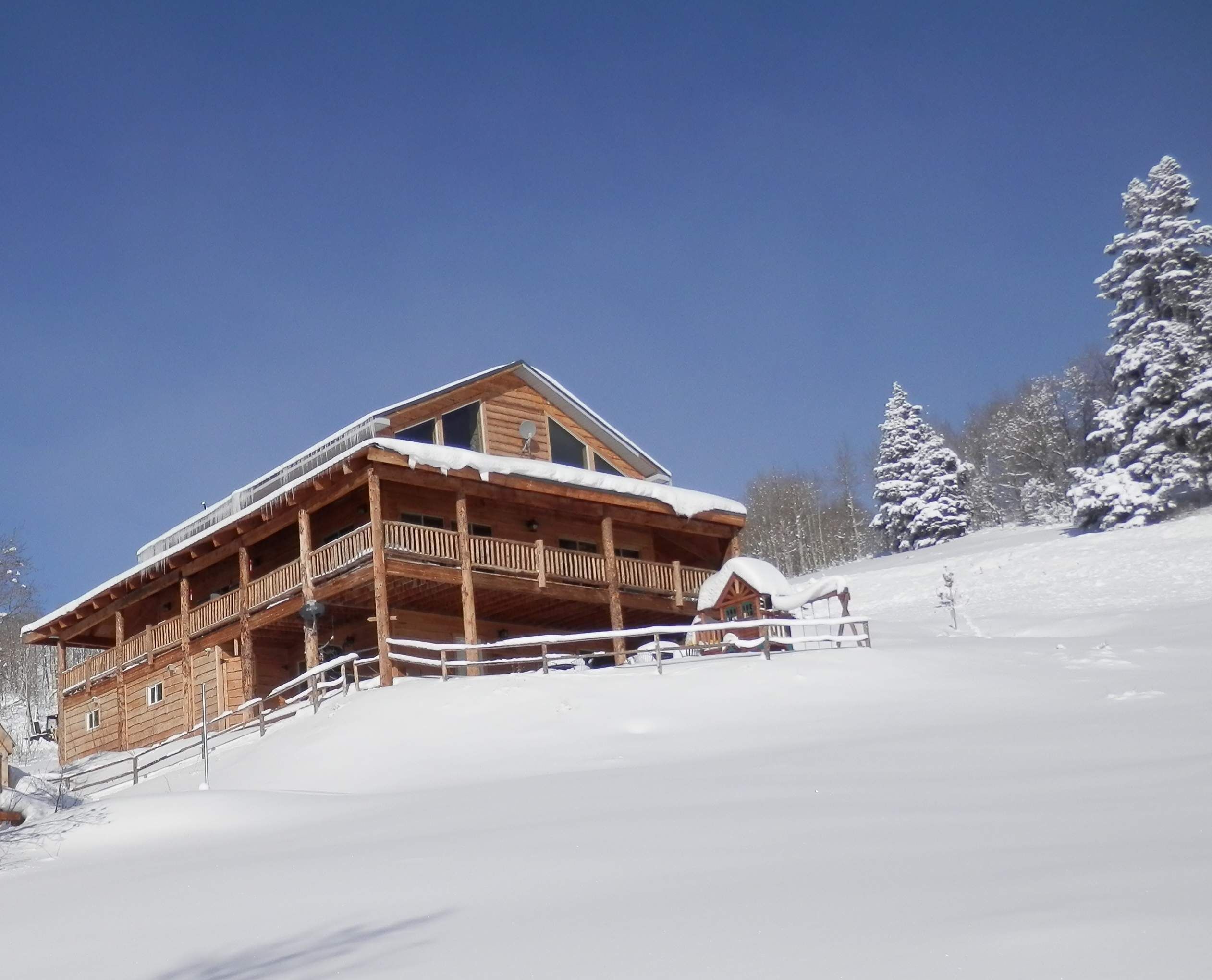 Silvercrest Lodge and driveway covered in winter snow