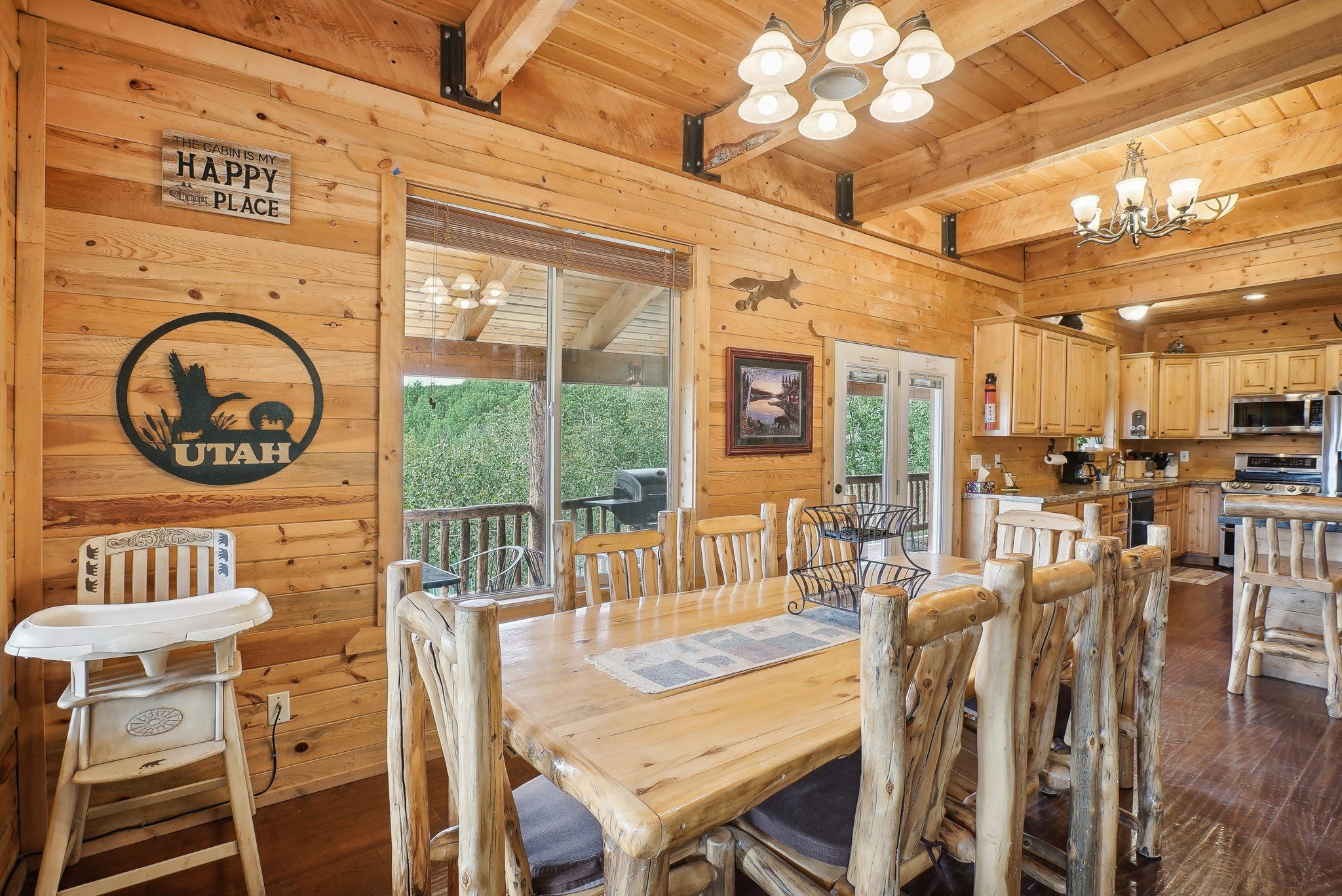 Dining table and three highchairs beside the kitchen