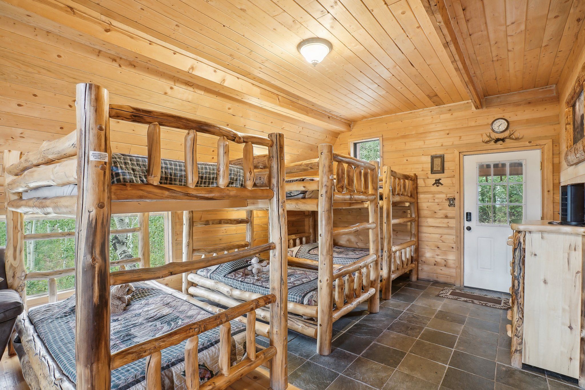 Eight handmade log twin bunks on the Bunkhouse main level