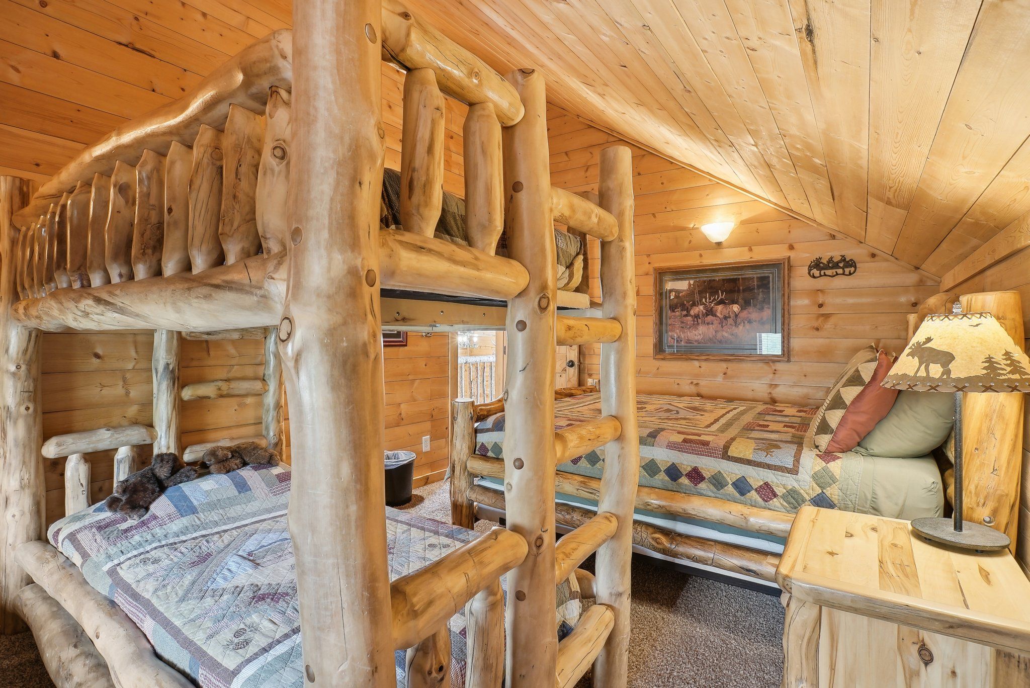 Handmade aspen-log twin bunks in the Elk Room