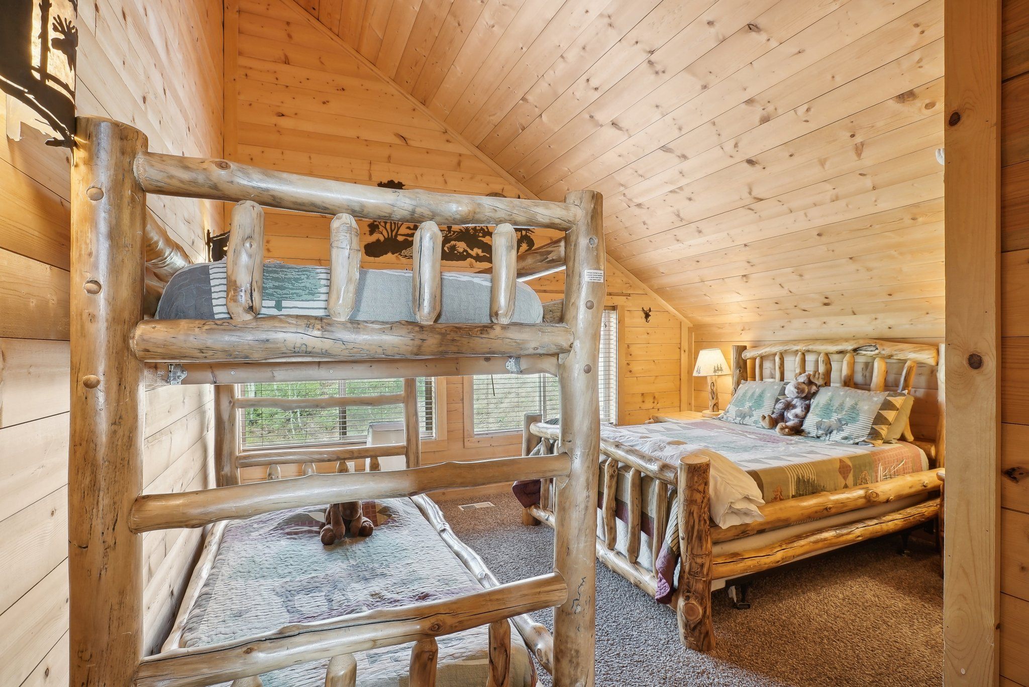 Moose Room with a queen bed and twin bunks under the vaulted ceiling