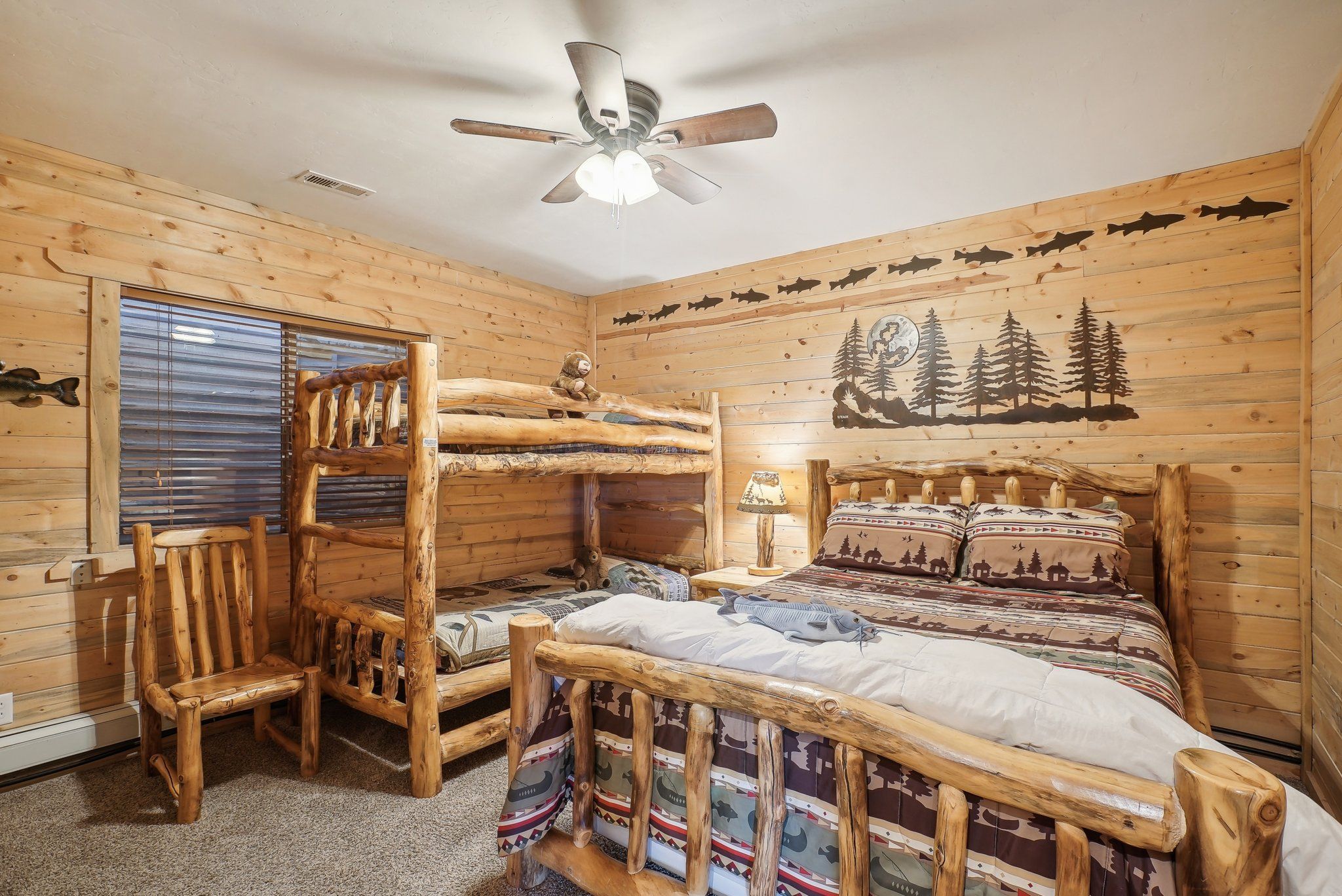 Lower-level bedroom with a queen bed and twin bunks