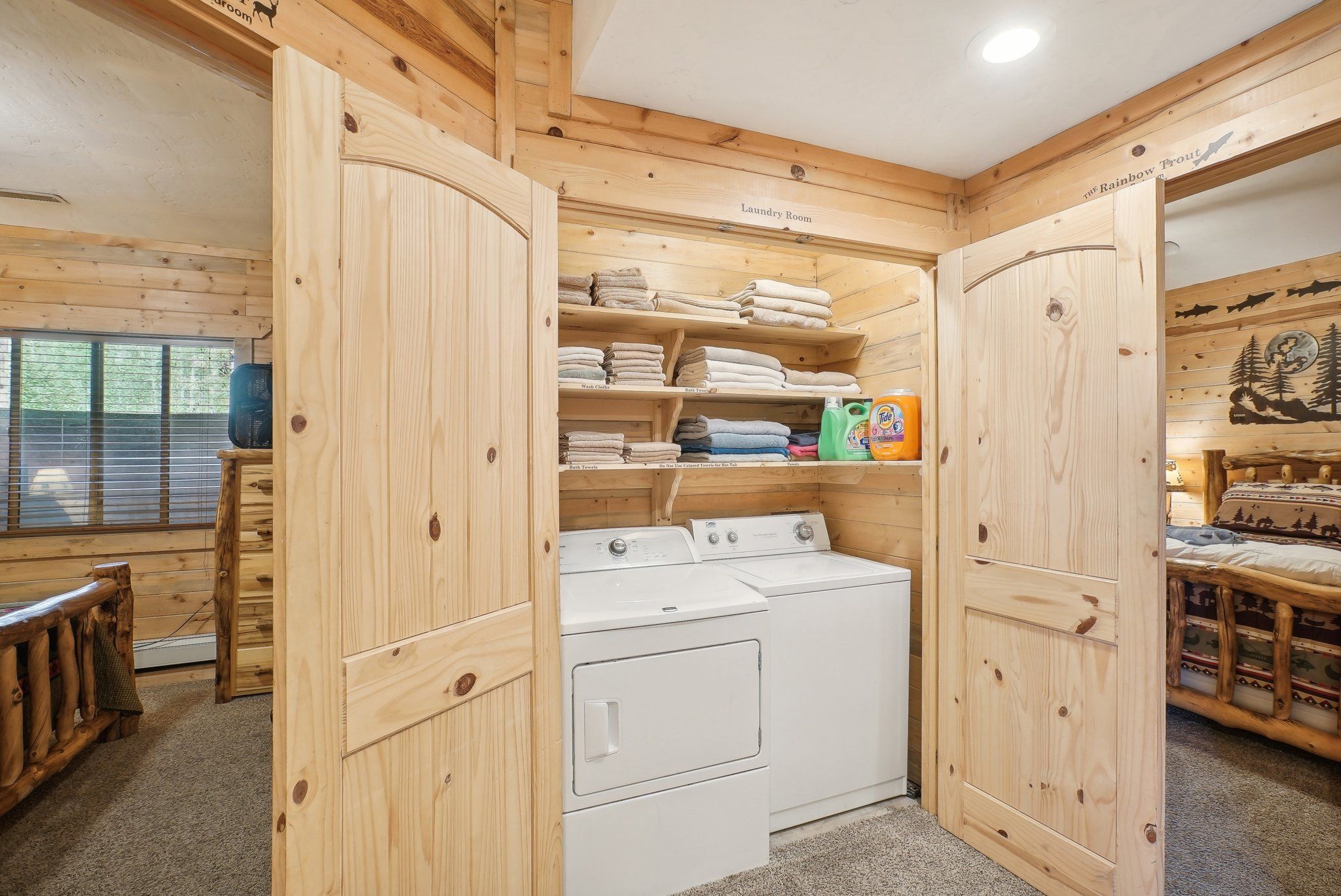 Laundry area with stocked linen shelves