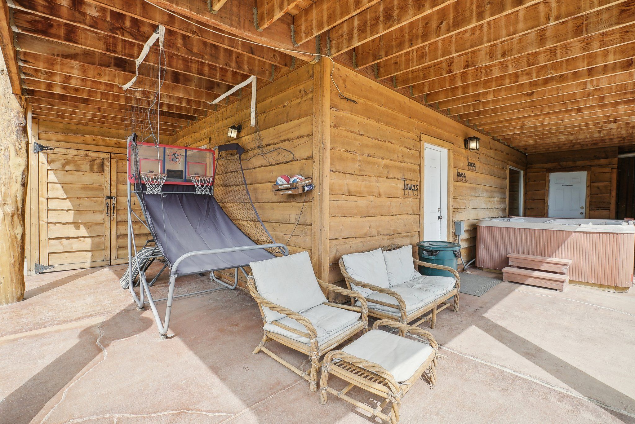 Basketball arcade and hot tub under the covered patio