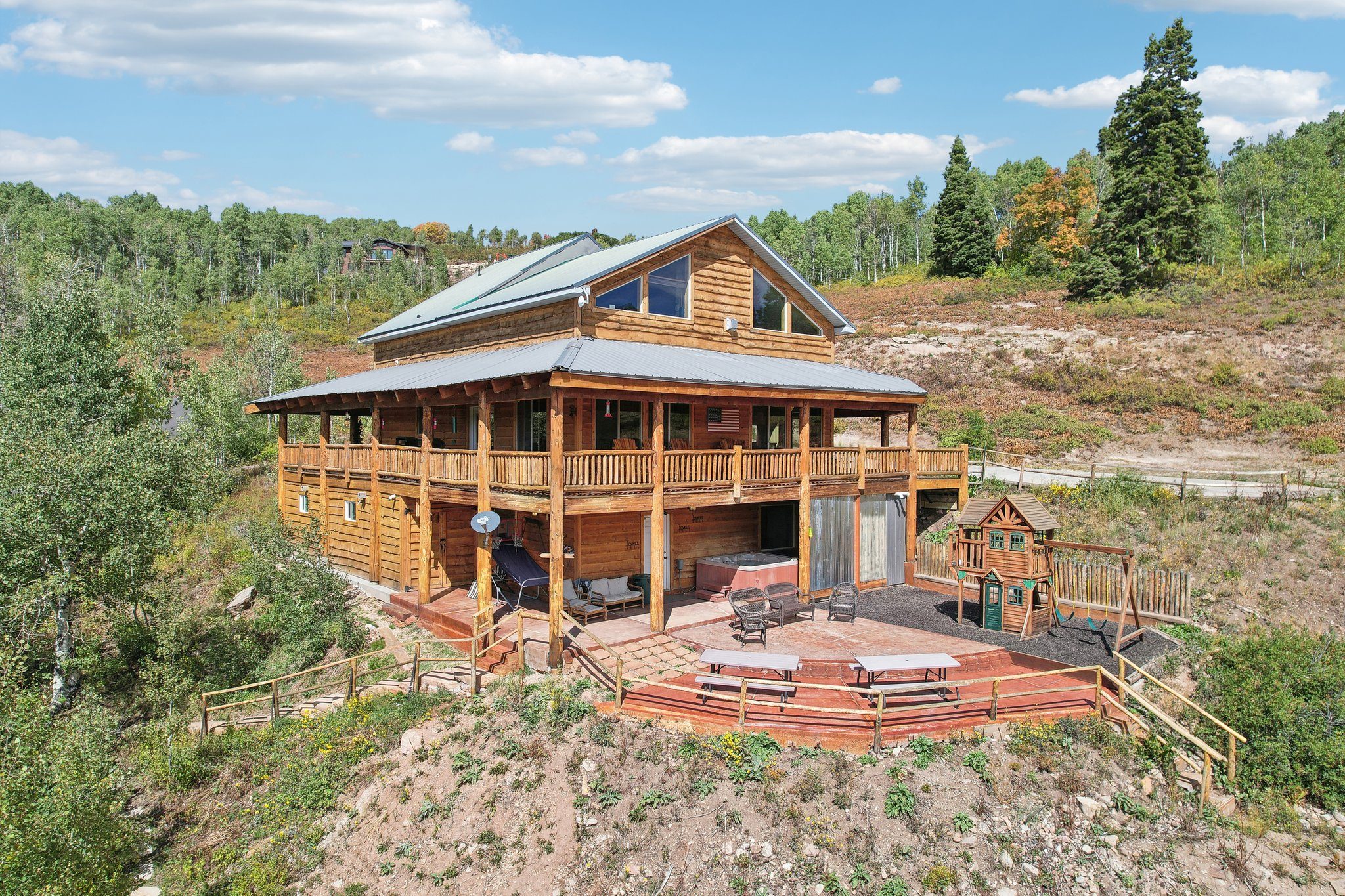 Aerial view of Silvercrest Lodge and the nearby Bunkhouse on an aspen-covered mountainside